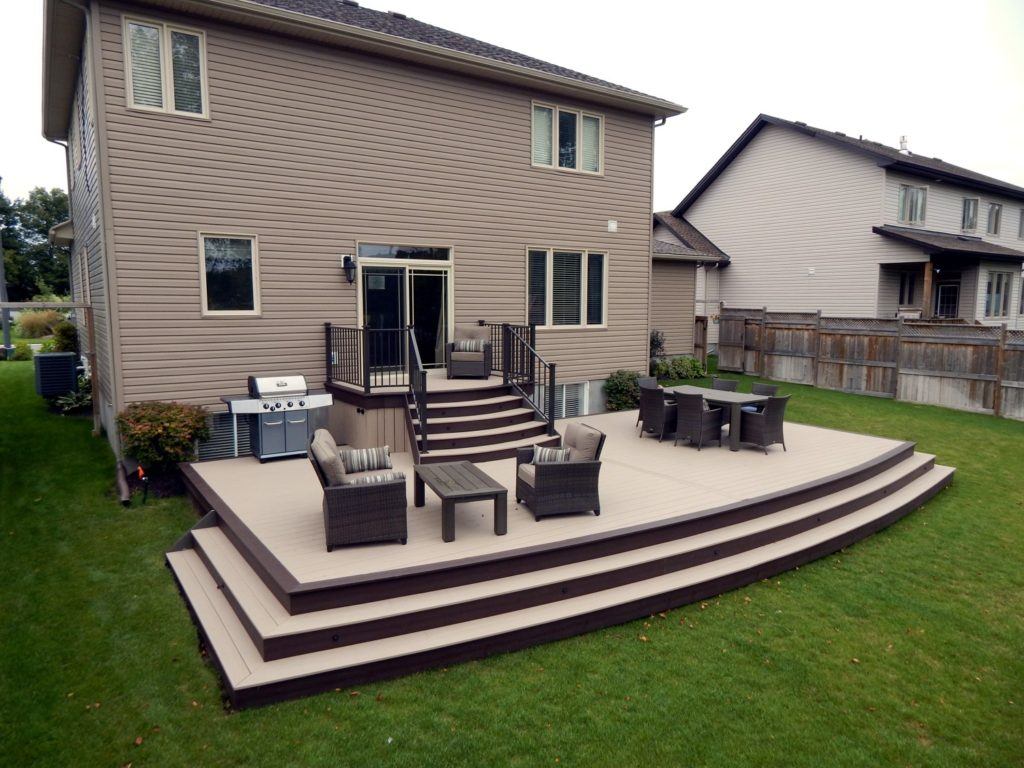 large brand new custom deck with chairs and tables in ottawa home backyard