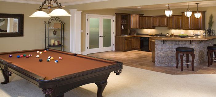 Recently finished residential lower level game room and bar with pool table and stools.