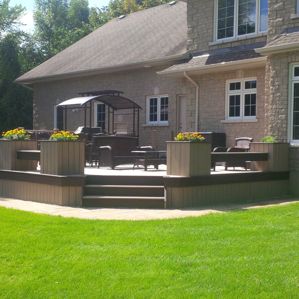 low height custom deck attached to modern home in Ottawa with planters around the perimeter