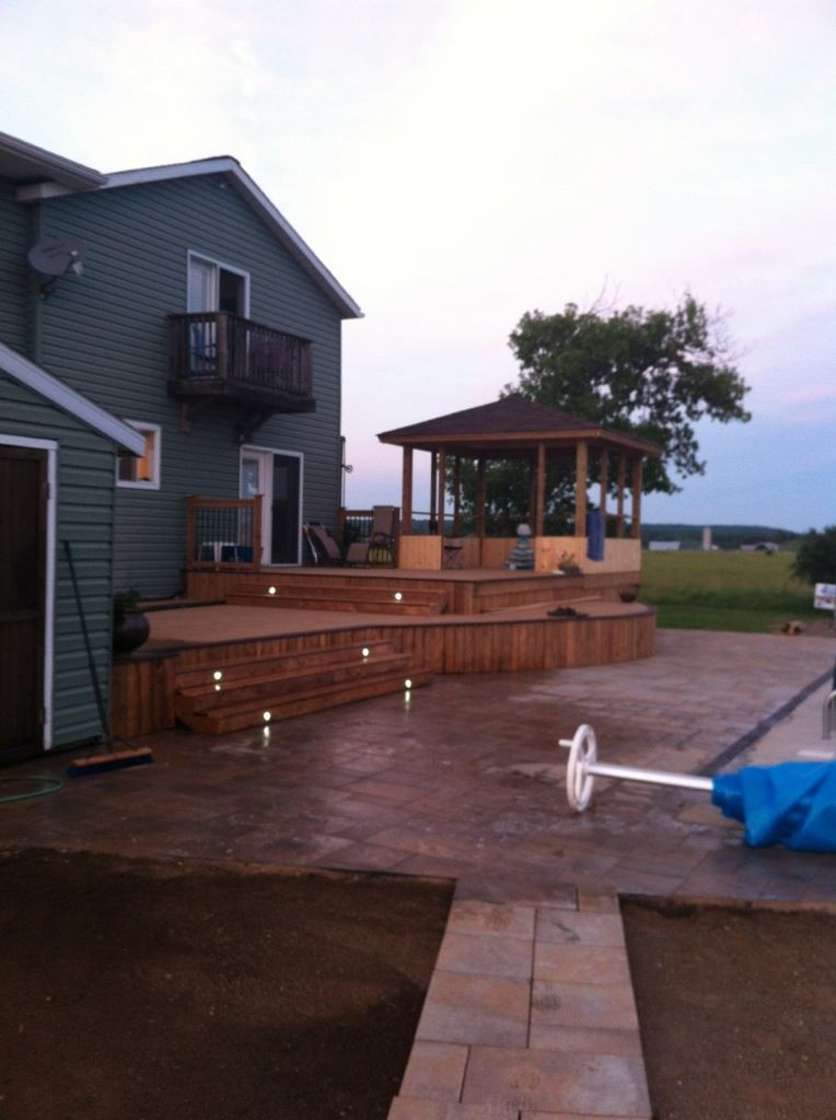 custom multi-level deck with pergola and lights embedded in the steps