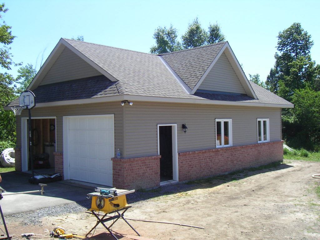 large detached two car garage with construction underway