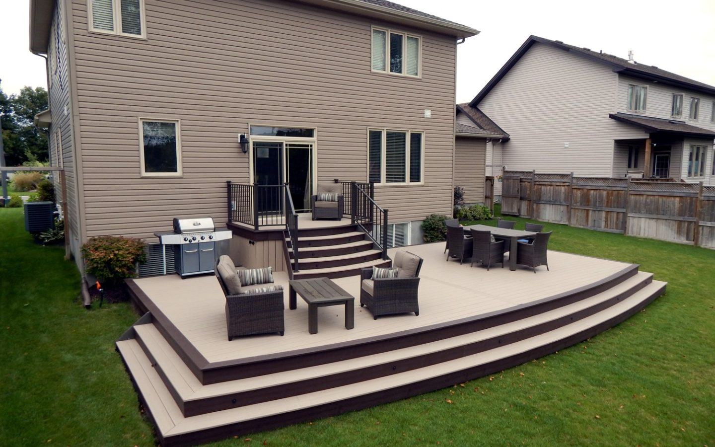 large brand new custom deck with chairs and tables in ottawa home backyard