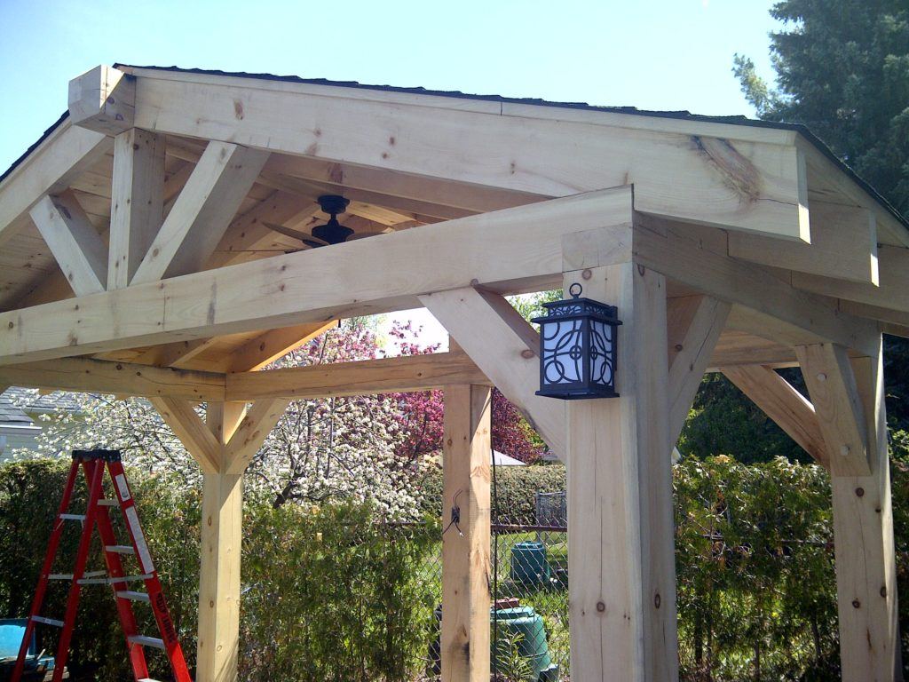 outer view of custom wooden pergola with lantern hanging on front post